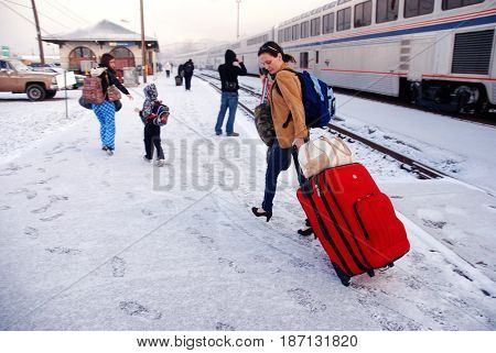 KLAMATH FALLS, OREGON, USA - February 25, 2012: Passengers disembark from an Amtrak train in snowy weather
