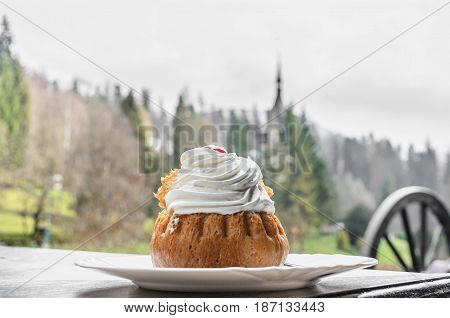 Savarin Cake With Cream And Syrup, White Plate, Outdoor Background