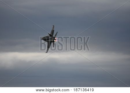 Albion Park, Australia - May 6, 2017. Silhouette of F18 Hornet fighter aircraft in flight. Clouds in the background. Wings Over Illawarra is an annual air show held at Illawarra Regional Airport.