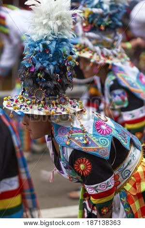 ORURO, BOLIVIA - FEBRUARY 26, 2017: Tinkus dance group in ornate costumes performing as they parade through the mining city of Oruro on the Altiplano of Bolivia during the annual carnival.