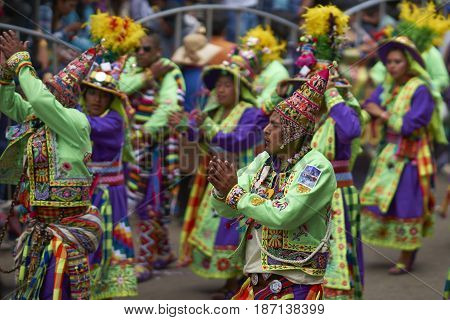 ORURO, BOLIVIA - FEBRUARY 26, 2017: Tinkus dance group in ornate costumes performing as they parade through the mining city of Oruro on the Altiplano of Bolivia during the annual carnival.