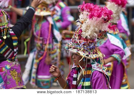 ORURO, BOLIVIA - FEBRUARY 26, 2017: Tinkus dance group in ornate costumes performing as they parade through the mining city of Oruro on the Altiplano of Bolivia during the annual carnival.