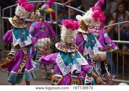 ORURO, BOLIVIA - FEBRUARY 26, 2017: Tinkus dance group in ornate costumes performing as they parade through the mining city of Oruro on the Altiplano of Bolivia during the annual carnival.
