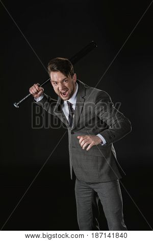 Angry Businessman Holding Baseball Bat And Screaming Isolated On Black