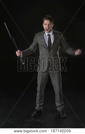 Angry Businessman Holding Baseball Bat And Screaming Isolated On Black
