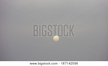 Magnificent White Sun Setting on Grey Skies