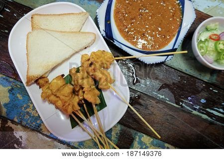 Grilled pork served with peanut sauce or sweet and sour sauce