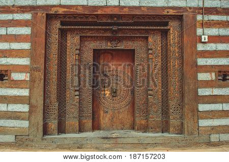Old wooden door with ornaments in the village of Vashisht.