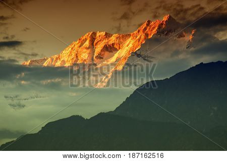 Beautiful last light from sunset on Mount Kanchenjugha Himalayan mountain range Sikkim India. color tint on the mountains at dusk