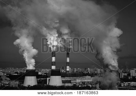 Industrial area of the city, smokestack pipes smoke mercilessly