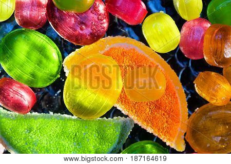 Delicious background, multicolored lollipops and slices of marmalade , top view