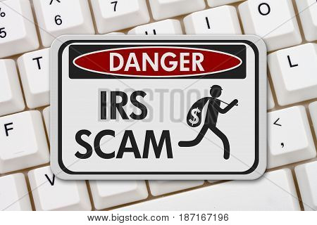 Tax scam danger sign A black and white danger sign with text IRS Scam and theft icon on a keyboard 3D Illustration
