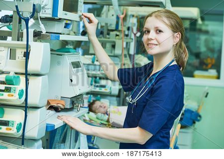 Female doctor portrait in front of intensive care unit for newborn infant baby