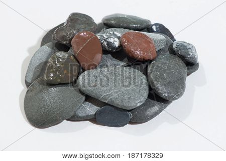 Stacked Rocks on a white background with color rocks on top