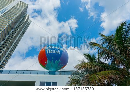 Maimi USA - June 28, 2012; Hallandale Beach Miami large circular retro colored sign on tall pole stands out near the beach.
