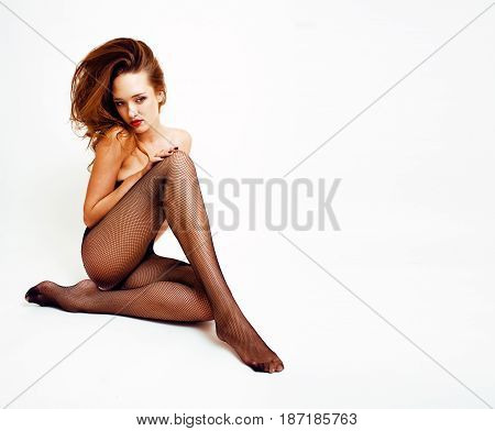 Sexy young real fashion woman in black pantyhose and lingerie, red lips, sexy look isolated on white background, seduction concept