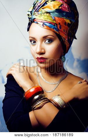 beauty bright real african woman with creative make up, shawl on head like cubian closeup smiling