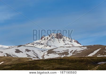 Horizontal Landscape Of Snow Covered Peak Of Erjiyes Mountain And Ski Resort In Spring With Some Sno