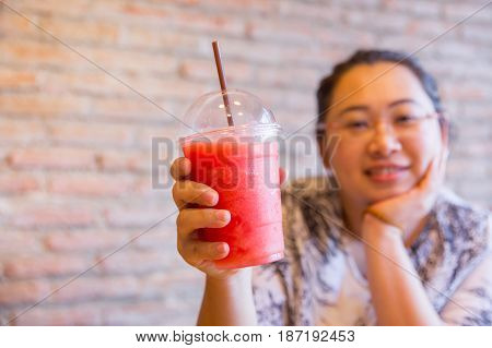 Fatty women tubby drinking fruit smoothie fruit healthy drink good for diet and cool ice for hot day in summer season.