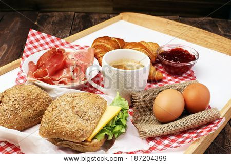 Breakfast On Table With Bread Rolls, Croissants, Coffe And Eggs