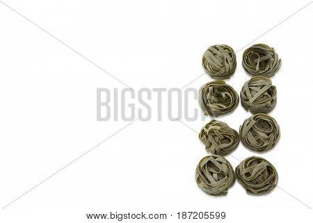 Overhead view of tagliatelle arranged on white background