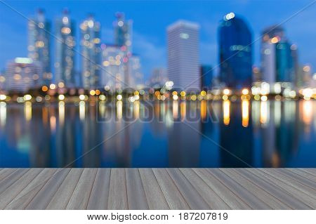 Opening wooden floor Twilight blurred bokeh light Office buildig with water reflection abstract background