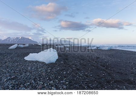 Ice on black rock beach form iceberg skyline in winter season Iceland natural landscape background