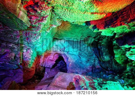 Entrance to ice cave. The hole in the cave, painted in fantastic colors