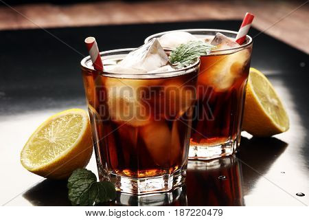 Softdrink With Ice Cubes, Lemon And Straw In Glass