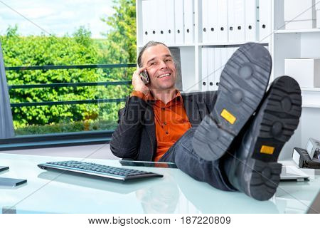 Business Man Behind His Desk In Summerly Hot Office