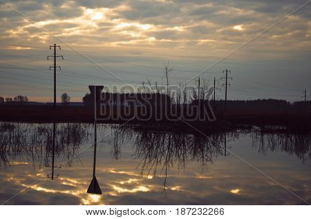 Road sign in puddle countryside spring twillight