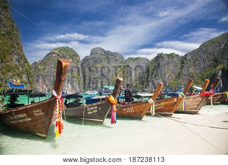 KO PHI PHI LEH, THAILAND, February 1, 2014: Traditional long tail boats on the beach of Maya Bay, Andaman Sea, famous tourist destination in the Ko Phi Phi achipelago