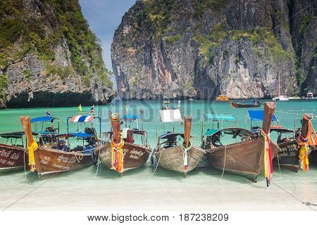 KO PHI PHI LEH, THAILAND, February 1, 2014: Traditional long tail boats on the beach of Maya Bay, Andaman Sea, famous tourist destination in the Ko Phi Phi achipelago