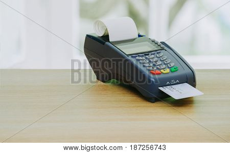 Credit card terminal or EDC machine on wooden background