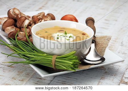 Creamy Mushroom Soup on white wooden background