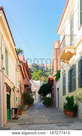 small cosy street of Placa district with Acropolis hill in Athens, Greece