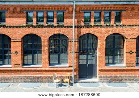 red brick building with large windows in the summer