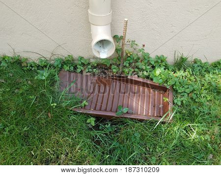 pvc gutter downspout pipe and green grass