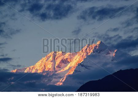 Beautiful last light from sunset on Mount Kanchenjugha Himalayan mountain range Sikkim India. color tint on the mountains at dusk