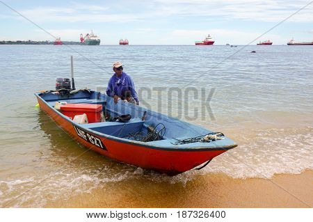 Labuan,Malaysia-Feb 19,2017:Traditional fisherman with fishing boat in beach of Papan island at Labuan Pearl of Borneo,Malaysia.