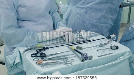 Laparoscopic surgery of the abdomen. The surgical nurse prepares the medical instrument