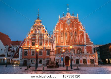 Riga, Latvia - July 1, 2016: Schwabe House And House Of The Blackheads At Town Hall Square, Ancient Historical Landmark And Popular Touristic Showplace In Summer Evening. Night Illuminations