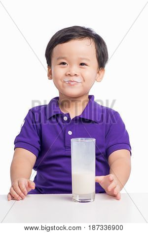 Adorable Baby Boy With Dringking Milk With Milk Mustache Holding Glass Of Milk