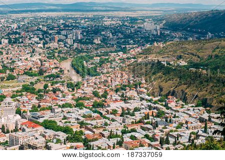 Tbilisi Georgia. Aerial View Of Hillside With Famous Landmarks: Tabor Monastery Of The Transformation, Narikala Fortress And Surb Gevorg Church Among Residential Area With Red And White Roofs.