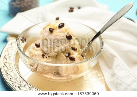 Glass bowl with delicious ice cream and chocolate candies on tray