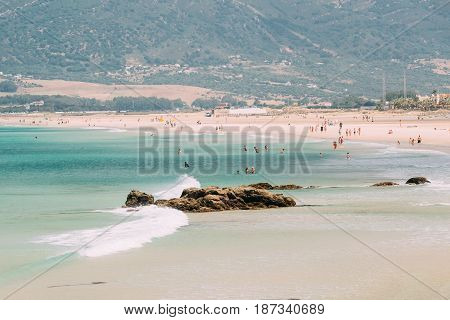 People resting at beach in Tarifa, Spain. Tarifa is most popular places in Spain for vacation