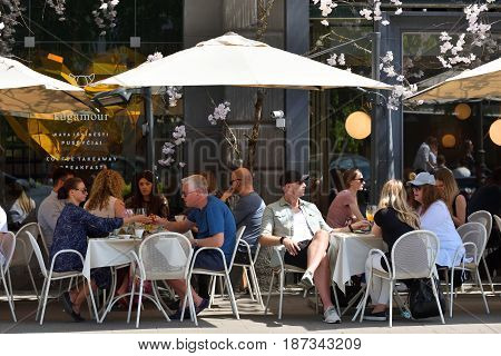 VILNIUS - MAY 20: Unidentified people in Vilnius Old Town cafe on May 20 2017 in Vilnius Lithuania. Vilnius is the capital of Lithuania and its largest city.