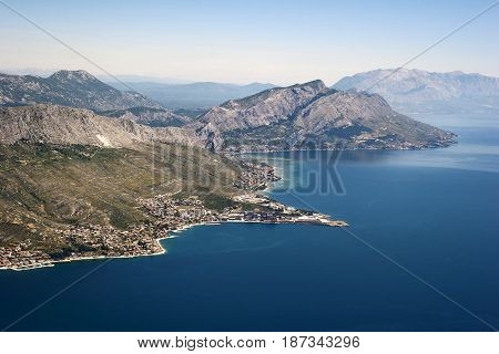 Aerial view - Omis riviera in Croatia town Dugi rat in front plan