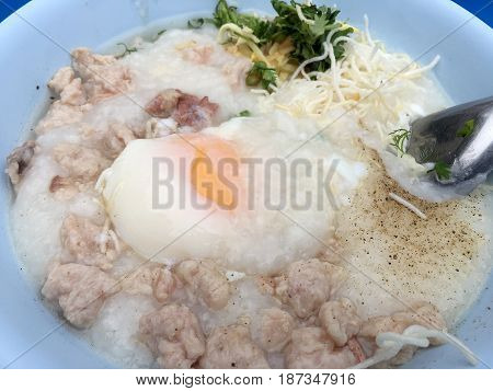 Traditional Thai Porridge Rice Gruel In White Bowl, Congee. In The Street Night Market.