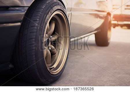 Racing rim wheels in retro car with selective focus.